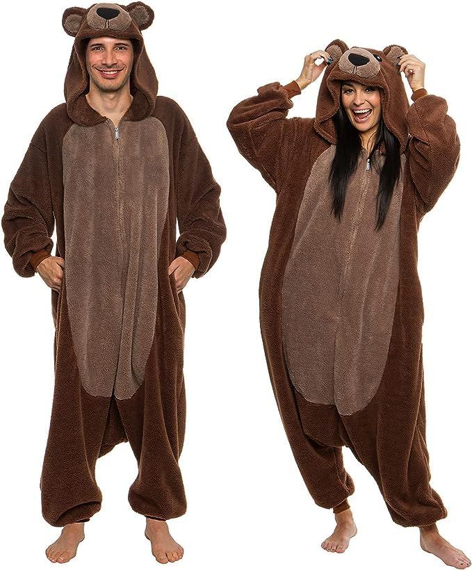 a man and woman in animal onesuits standing next to each other, one wearing a bear costume