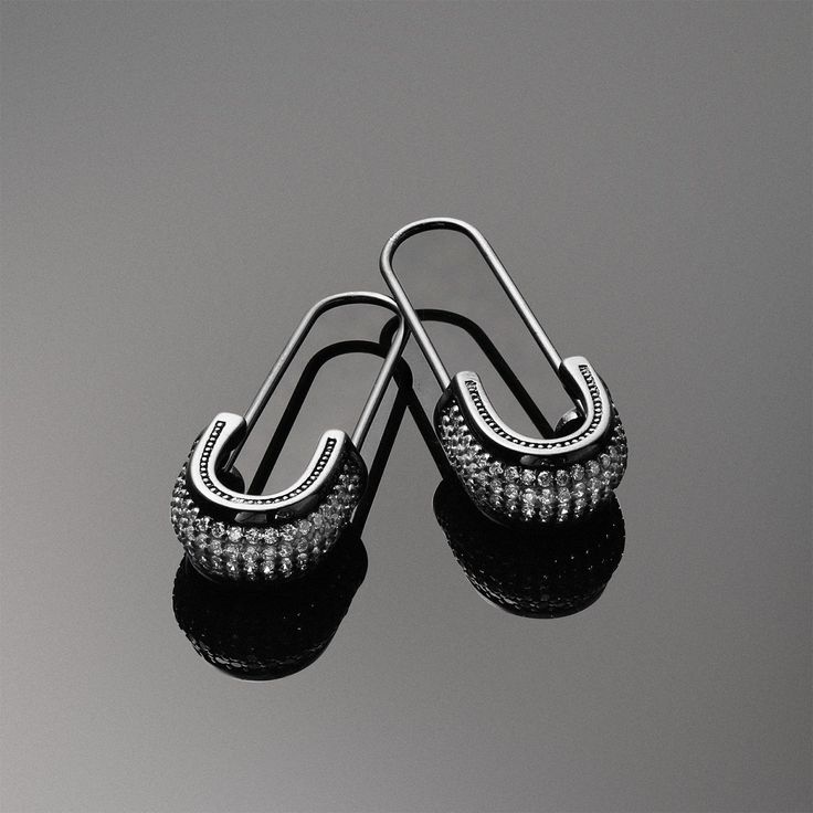 Safety pin jewelry is back in style and ready to add an edgy vibe to your looks. These sterling silver earrings are black rhodium plated and adorned with sparkling CZ accents.  If you are a fan of gothic jewelry, these black earrings will be an ideal addition to your collection. Make these Threader earrings your new go to pair of silver earrings. Nickel-free Black Punk Earrings, Black Sterling Silver Edgy Earrings, Black Edgy Sterling Silver Earrings, Black Nickel-free Punk Earrings, Edgy Black Sterling Silver Earrings, Edgy Black Earrings For Streetwear, Nickel-free Black Jewelry For Streetwear, Black Punk Metal Earrings, Black Nickel-free Jewelry For Streetwear