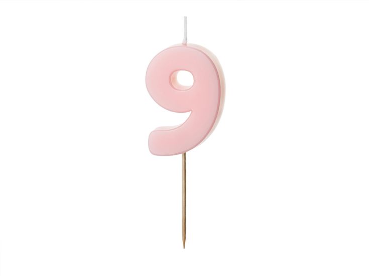 a pink number nine candle on a stick