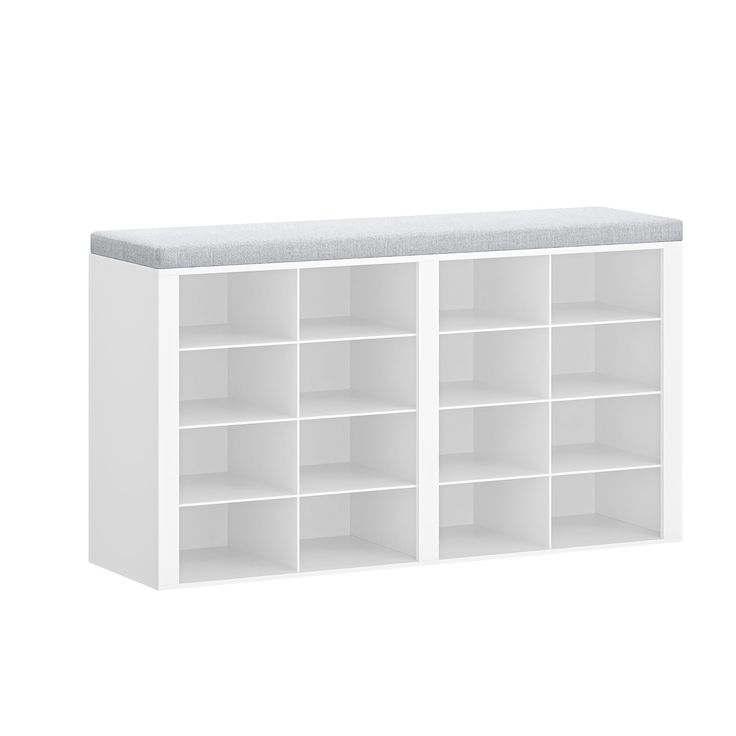 a white bookcase with several compartments and a cushion on the top one shelf is empty