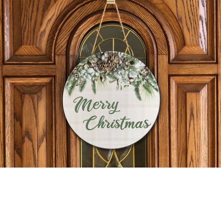 a wooden door with a merry christmas sign hanging from it's front glass window