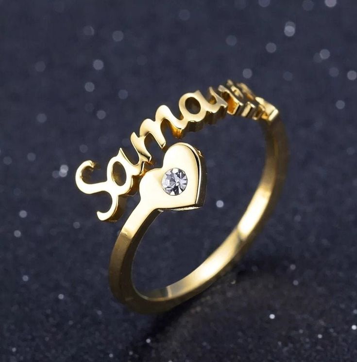 "Description:-  It will make you exciting to see your or your loved once name on this jewelry. Material: Stainless steel Plating: 18K Silver or Gold or Rose Gold Ring Size:- 7, 8, 9, 10 GEM:- Cubic Zirconia If you want Solid Rose gold, Gold or Yellow Gold, let us know we can also make that for you on request.  → [How to process the order] 1. Please tell us the name and Font Number in the 'Personalization Box' Above For Example- Jennifer + Font 1 Note: if you do not choose a font, we will make font#2 for you. and select the finish, Size, etc from the menu option. 2. Now, click on \"Pay with Paypal\" OR \"Add to basket\" . At the checkout page, you can choose to either pay with your PayPal account or you can pay with a \"credit/debit card\". 3.If you have a special request like a gift messag Customizable Nameplate Jewelry For Promise, Personalized Heart Ring As A Gift, Heart-shaped Rings For Valentine's Day Personalized Gift, Personalized Adjustable Heart Cut Ring, Customizable Promise Rings For Valentine's Day, Personalized Gold Heart Ring For Anniversary, Customizable Heart-shaped Ring For Mother's Day, Personalized Gold Rings For Valentine's Day, Customizable Heart Ring For Valentine's Day