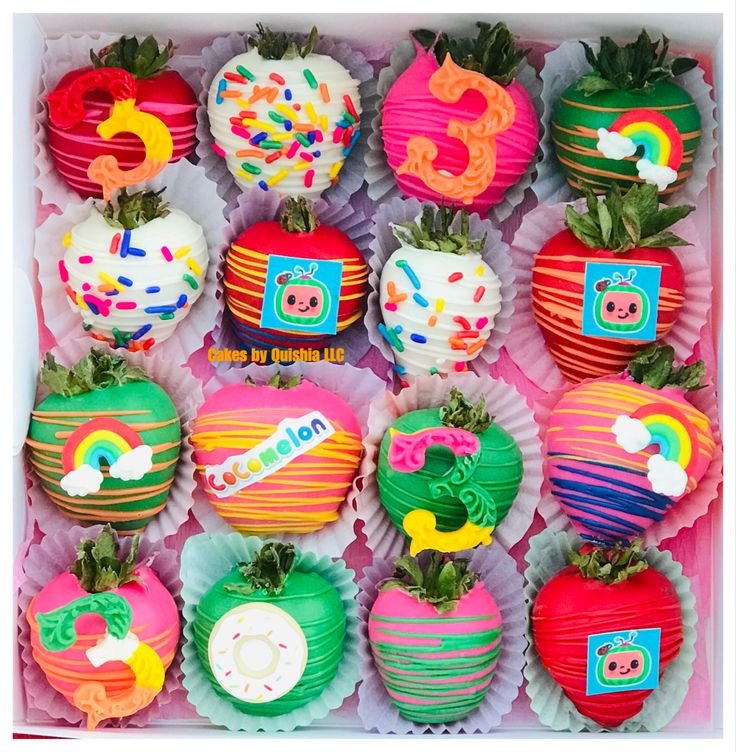 a box filled with lots of colorful cupcakes