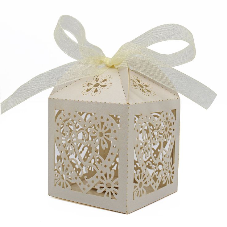 a small white box with a ribbon on it and a bow tied around the top