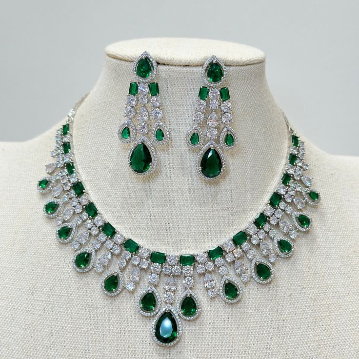 Emerald CZ diamond bridal necklace, American Diamond wedding necklace, Cz jewelry, Indian, Pakistani, and Punjabi wedding jewelry  Regular Size And Adjustable with rhodium finish Ships from California, USA Delivery in 2-5 business days in the USA. Other colors can be found here https://www.etsy.com/listing/1423096838/ruby-cz-diamond-bridal-necklace-american?ref=listings_manager_grid https://www.etsy.com/listing/1423097794/sapphire-cz-diamond-bridal-necklace?ref=listings_manager_grid Color, shade Anniversary Emerald Necklace With Cubic Zirconia Jewels, Brilliant Cut Emerald Necklace For Wedding, Dazzling Brilliant Cut Emerald Necklace For Wedding, Wedding Emerald Necklace With Diamond Accents, Emerald Necklace With Diamond Cut For Wedding, Wedding Diamond Necklace With Jewels In Cubic Zirconia, Fine Jewelry Emerald Necklace For Wedding, Emerald Necklace For Wedding Fine Jewelry, Hand-set Cubic Zirconia Emerald Necklace For Wedding