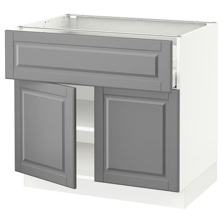 a gray and white kitchen cabinet with two doors on one side, an open drawer on the other