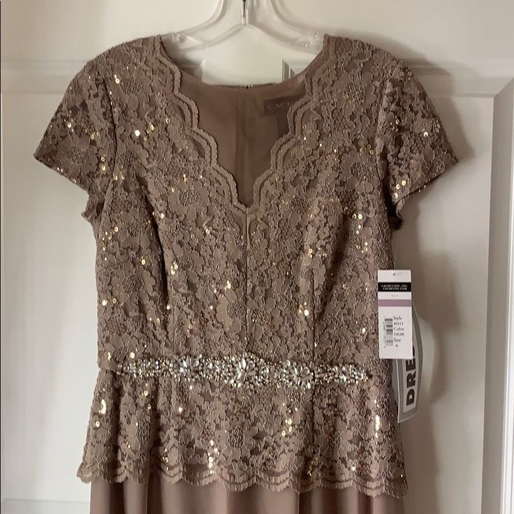 Short Sleeve Taupe Stretch Lace V-Neck Bodice With Stretch Mesh Skirt And Beaded Waist Detail. Brand New. Never Worn. 100% Polyester; 64% Nylon, 34% Polyester, 2% Spandex Imported Hand Wash Short Sleeve Gown With Full Skirt Gown With Short Sleeves Fitted V-neck Maxi Dress For Mother Of The Bride, Gown With Short Sleeves, Short Sleeve Gown, Sleeve Gown, Mesh Skirt, Gowns With Sleeves, Lace Gown, Stretch Lace, Full Skirt