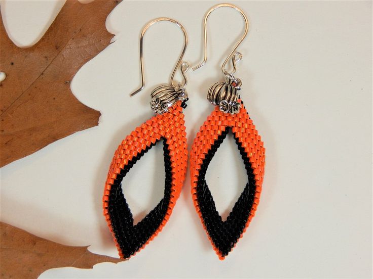 Orange and Black Seed Bead Halloween Earrings with Pumpkin Charm (HE16) by ClassyBeadsandBangle on Etsy Orange Dangle Earrings With Black Beads, Orange Dangle Jewelry With Black Beads, Orange Dangle Beaded Earrings With Black Beads, Orange And Black Beads Dangle Earrings, Orange Teardrop Beaded Earrings With Ear Wire, Orange Earrings With Black Beads As Gift, Orange Earrings With Black Beads For Gift, Orange Teardrop Beaded Earrings, Seed Bead Halloween