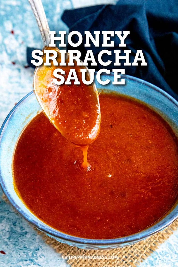 honey sriracha sauce in a blue bowl with a spoon sticking out of it