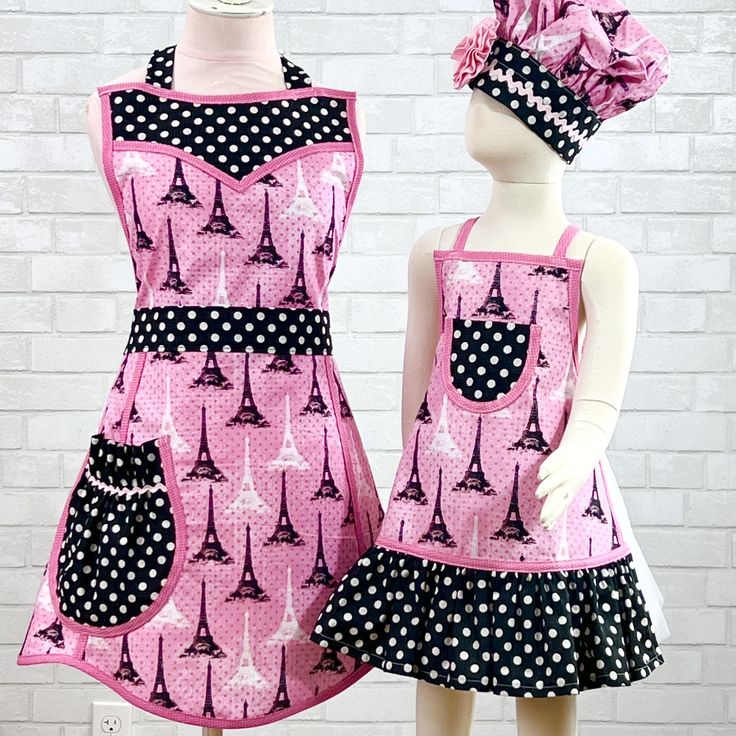 two mannequins dressed in pink and black dresses with polka dots on them