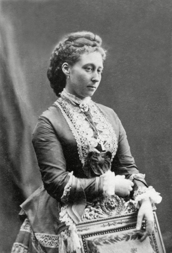 an old photo of a woman in a dress