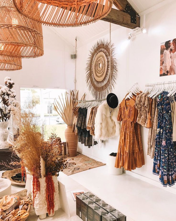 a room filled with lots of different types of clothing hanging from the ceiling and baskets on the wall