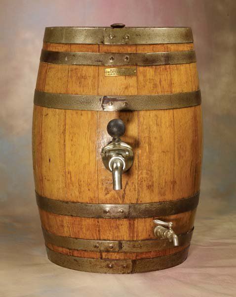 an old wooden barrel with a faucet on it