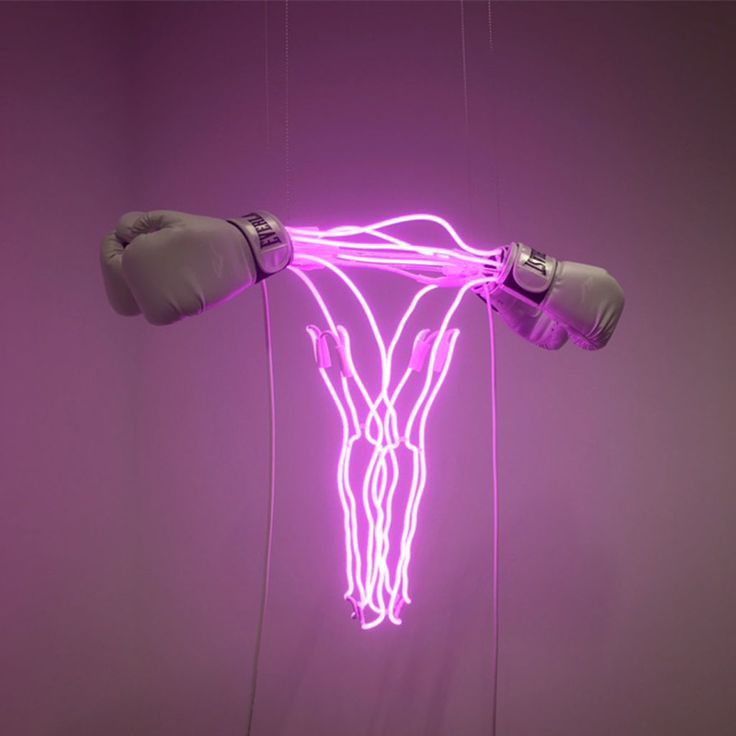 a neon sculpture with boxing gloves hanging from it's sides