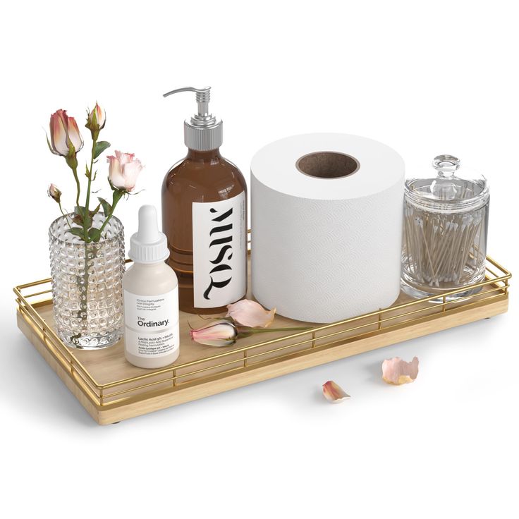 a wooden tray with bottles and soaps on it, including a roll of toilet paper