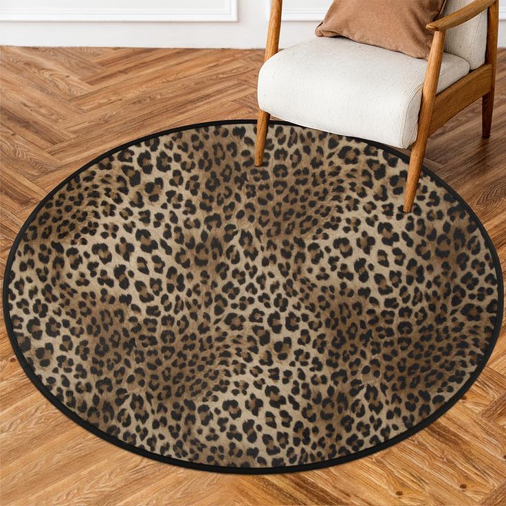 a leopard print area rug in a living room with a chair and wooden flooring