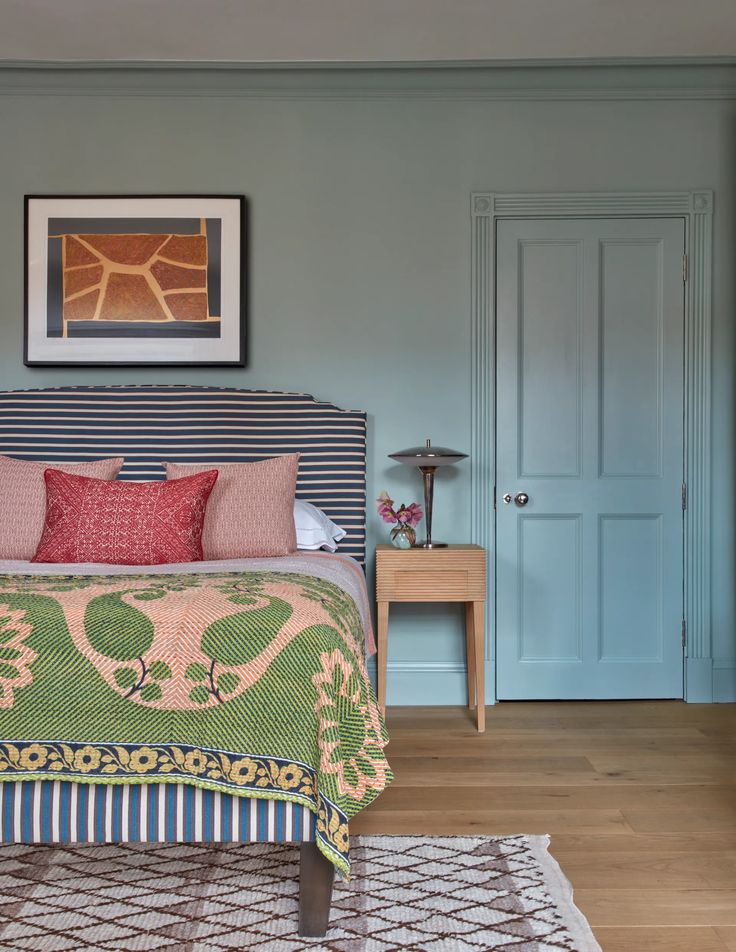 a bed sitting in a bedroom next to a blue door