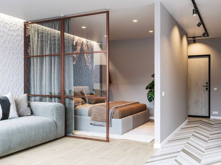 a living room filled with furniture next to a white wall