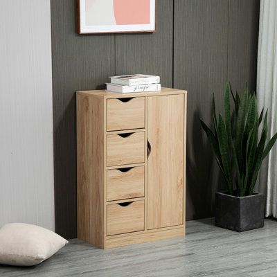 a wooden cabinet sitting next to a potted plant