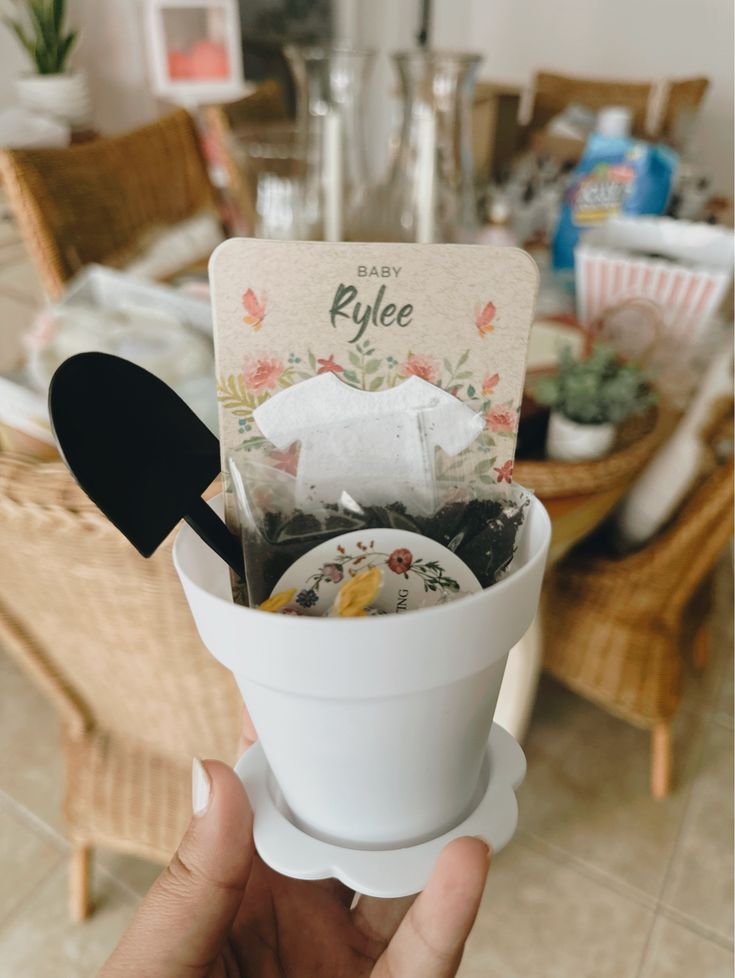 a person holding up a cup filled with food