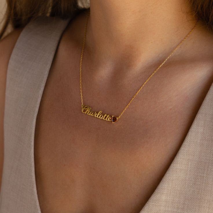 This sweet little Mellow Name Heart Birthstone Necklace is the perfect made-to-order, minimalist essential to add to your jewelry box. The delicate and feminine design will add a lovely touch to any outfit you throw on. Material: High Quality Solid 925 Sterling Silver Finish: Sterling Silver ∙ 18K Gold ∙ Rose Gold Dimensions: Depending on your font choice, height sizes range from 3mm to 5mm lowercase | ~6x6mm Genuine CZ Heart Gemstone. Size: The total necklace length includes the chain + charm ( Minimalist Birthstone Charm Necklace As Gift For Her, Classic Charm Necklaces With Delicate Chain For Gift, Dainty Name Necklace With Delicate Adjustable Chain, Dainty Custom Name Pendant Charm Necklace, Dainty Everyday Charm Necklaces For Mother's Day, Delicate Everyday Charm Necklaces For Mother's Day, Minimalist Charm Necklace With Delicate Chain For Mother's Day, Delicate Clavicle Chain Jewelry For Valentine's Day, Minimalist Tarnish-resistant Charm Necklaces For Mother's Day