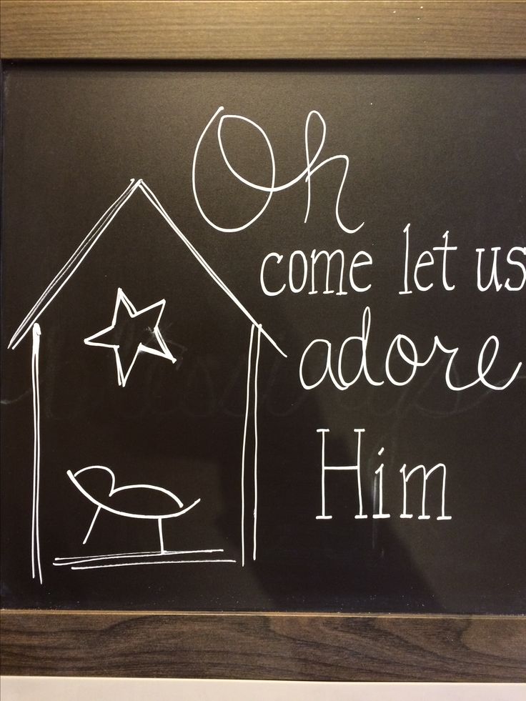 a chalk board with the words oh come let us adore him