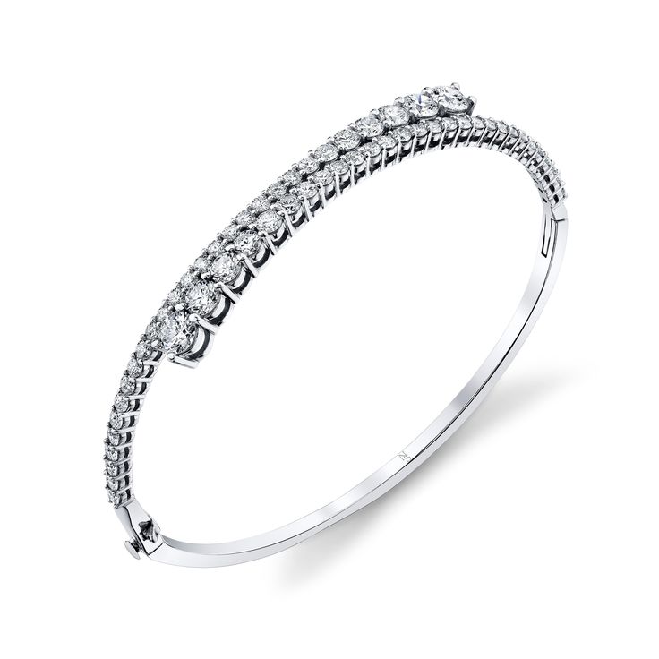 Elevate your wrist game with our exquisite Diamond Bypass Bangle Bracelet, an emblem of luxury and sophistication. This bracelet showcases round diamonds meticulously set in a stunning bypass design, radiating timeless beauty Formal Diamond Cuff Bracelet Fine Jewelry, Diamond Cuff Bracelet With Brilliant Cut, Formal Cuff Bracelet With Brilliant Cut Diamond, Formal Diamond Cuff Bracelet With Brilliant Cut, Modern White Gold Diamond Bracelet With Accents, White Gold Diamond Accents Bangle Bracelet, Modern White Gold Diamond Bangle With Diamond Accents, White Gold Diamond Accents Bangle, Formal Cuff Bracelet With Brilliant Cut