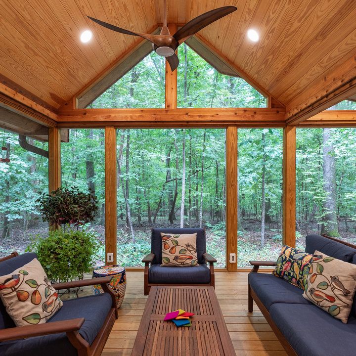 a living room filled with furniture and a ceiling fan in the middle of a room