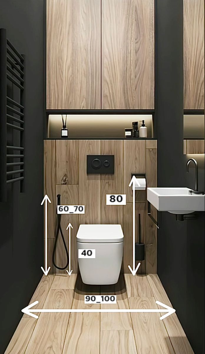 a bathroom with wood paneling and white fixtures, including the measurements for the toilet