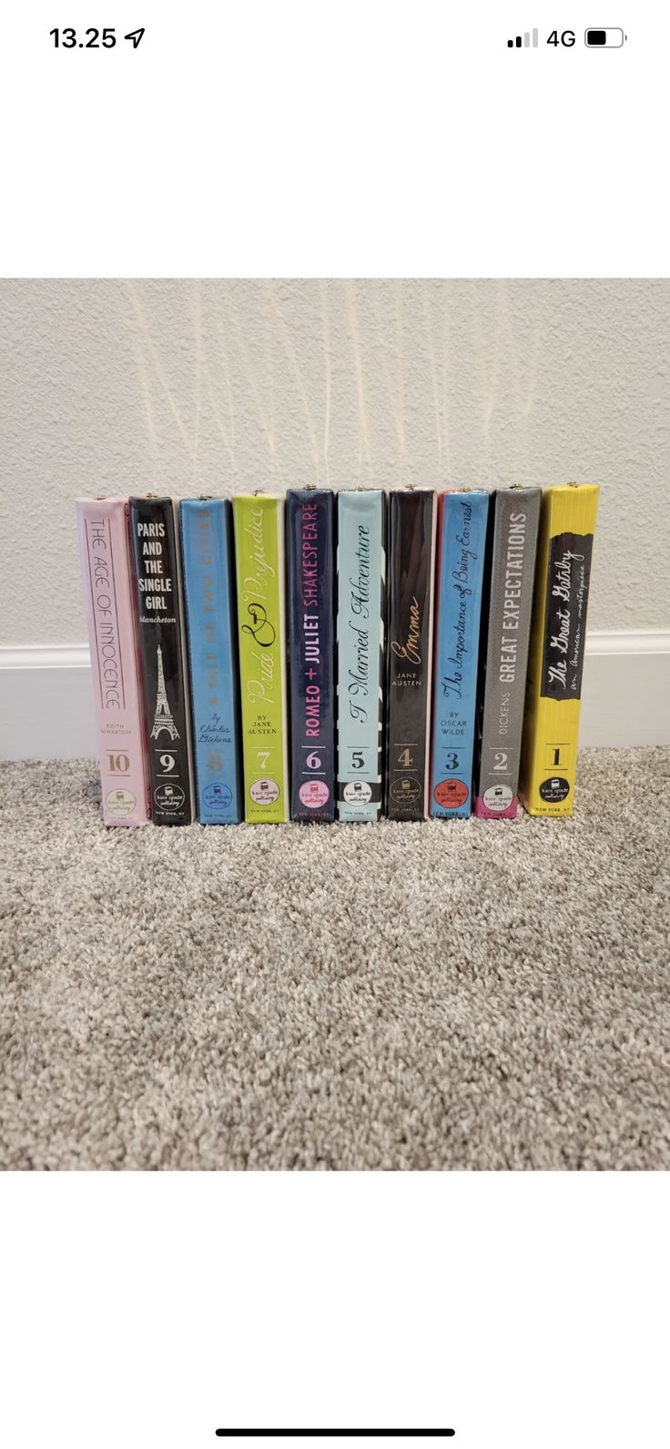 a row of books sitting on top of a carpet