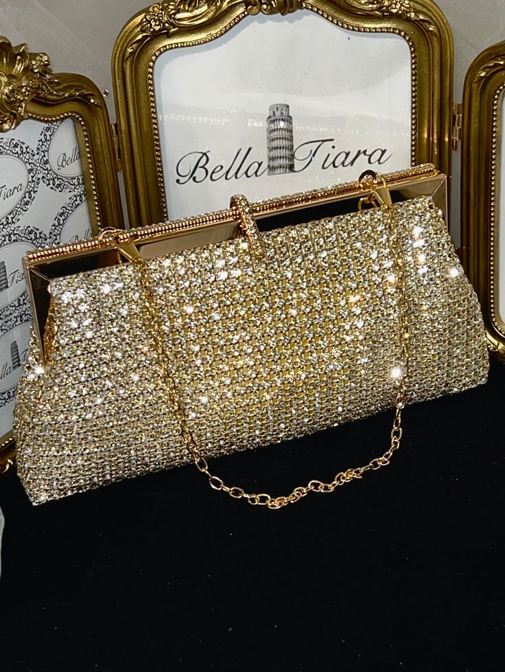 BELLA TIARA INTRODUCES OUR ELEGANT CRYSTAL PURSE COLLECTION A MUST HAVE FOR ANY SPECIAL OCCASIONAbsolutely stunning, dazzling, glamorous and elegant. Our Adora swarovski crystal clutch purse is perfect for all your essentials, soft and elegant removable chain satin lined. crystal all around, soft satin lined perfect for any size cell phone gold setting with swarovski crystalsmeasures approx 8" long x 3 3/4" high. -------------------------------------- *Note processing time is not shipping time, Glamorous Evening Bags With Gold-tone Hardware, Glamorous Evening Shoulder Bag With Gold-tone Hardware, Elegant Gold Crystal Clutch, Elegant Gold-tone Clutch Evening Bag, Gold Embellished Crystal Clutch, Gold Clutch Purse, Crystal Purse, Gold Clutch, Crystal Clutch