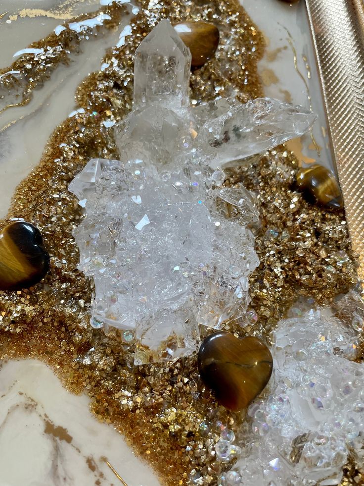 some rocks and ice on top of a white plate with gold flecks in it