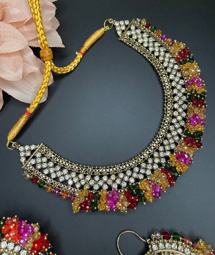 high quality diamond choker/indian multi color set/pakistani choker/jaago haldi sangeet/wedding tikka and earrings This beautiful choker comes with matching earrings, ring and tikka and can be paired separately for a simple look. The colors are multi and is made of cubic zirconia stones for a gorgeous sparkle. Bollywood Style Multicolor Lehenga With Stone Work, Festive Multicolor Lehenga With Stone Work, Multicolor Hand Set Kundan Jewelry Sets, Heavy Multicolor Bridal Sets For Festive Occasions, Multicolor Kundan Jewelry Sets Hand Set, Bollywood Style Multicolor Meenakari Tikka, Multicolor Lehenga With Stone Work For Wedding, Multicolor Chandbali Bridal Necklace With Hand Set, Multicolor Hand Set Bridal Necklace For Party