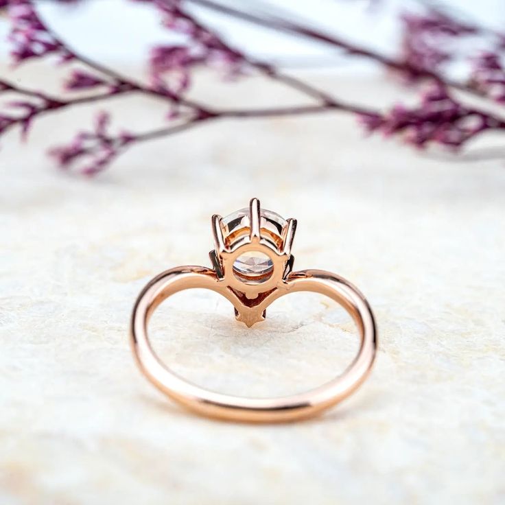 Discover the ethereal beauty of the Lunar Serenity Ring, an exquisite blend of minimalist design and celestial charm. Crafted in radiant rose gold, this piece features a mesmerizing round-cut moonstone that captures the moon’s gentle glow, offering a sense of calm and mystery. The delicate star-shaped accent adds a whimsical touch, perfectly symbolizing the harmony between earth and sky. Designed for the modern romantic, this ring celebrates understated luxury, making it the perfect choice for those who appreciate elegance with a touch of celestial magic. Whether worn as a statement piece or paired with other jewelry, the Lunar Serenity Ring radiates timeless beauty and sophistication. 𝗗𝗘𝗧𝗔𝗜𝗟𝗦 𝗠𝗔𝗜𝗡 𝗦𝗧𝗢𝗡𝗘𝗚𝗲𝗺𝘀𝘁𝗼𝗻𝗲: Natural Moonstone𝗖𝗼𝗹𝗼𝗿: Blue𝗦𝗵𝗮𝗽𝗲: Round 6. 14k Gold Minimalist Moonstone Promise Ring, Rose Gold Moonstone Ring For Promise, Dainty Rose Gold Moonstone Ring, Elegant Moonstone Rings With Prong Setting, Minimalist 14k Rose Gold Moonstone Ring, Minimalist Rose Gold Moonstone Promise Ring, Rose Gold Moonstone Halo Promise Ring, Rose Gold Round Moonstone Ring With Halo, Elegant Rose Gold Moonstone Promise Ring