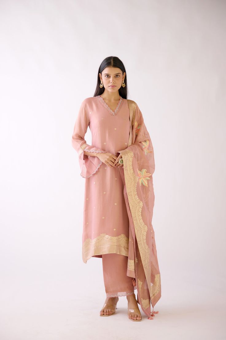 Stunning dusty pink embroidered Banarasi weave kurta set is a perfect festive wear. It comes with a matching dupatta. Shop online from Pure Elegance. Disclaimer: The actual product may vary slightly from the image. These are custom orders, hence expect slight variation in color and placement of the motif or buta. ESTIMATED DELIVERYBecause this is a custom order, it would take about 4 weeks from the date of purchase. RETURN POLICYThis product is a custom order and cannot be returned or exchanged. Pink Slub Silk Palazzo Set With Zari Work, Festive Pink Slub Silk Palazzo Set, Pink Slub Silk Palazzo Set With Dabka Work, Pink Slub Silk Salwar Kameez For Eid, Unstitched Pink Slub Silk Salwar Kameez, Pink Raw Silk Palazzo Set With Chikankari Embroidery, Traditional Pink Slub Silk Salwar Kameez, Pink Embroidered Slub Silk Churidar, Pink Chikankari Embroidered Dupatta In Slub Silk