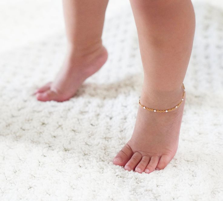 This delicate bead chain anklet is a charming addition to any ensemble, especially during the spring & summertime! These anklets look great on their own or paired with others. Choose from several different color options. The anklets are hypoallergenic, water-resistant, and tarnish-resistant. To keep your jewelry in optimal condition, avoid long exposure to water, harsh chemicals, lotions, oils, and sunscreen. For the best fit, measure your ankle with a string before ordering to ensure you choose the right size. Each anklet includes a 1-inch extender chain. Average sizes are as follows: 0-6 Months: 5" 6-12 Months: 5.5" 1-3 Years: 6" 3-6 Years: 6.5" 6-12 Years: 7" If you have any questions, feel free to reach out! Toddler Jewelry, Gold Anklet, Baby Jewelry, Bead Chain, Chain Anklet, Long Exposure, Anklet Jewelry, Body Jewellery, Beaded Chain