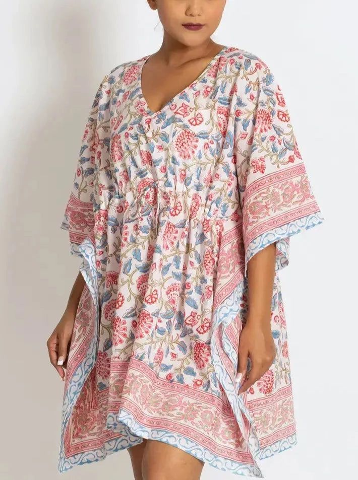 This soft 100% cotton caftan from Sevya makes a great swimsuit coverup or comfy dress! This breezy, lightweight, cotton caftan mini dress features an adjustable drawstring gather at the waist for whether you prefer a relaxed or fitted look. The material is hand stamped by artisans in Rajasthan, India. The wooden blocks are first hand-carved and the design is then hand-stamped using a different block for each color in the pattern. The seamless printing shows the fine skill of the block-printers, Bohemian V-neck Kaftan For Vacation, Summer V-neck Tunic For Loungewear, Beach V-neck Printed Kaftan, V-neck Floral Print Tunic For Beach Cover-up, Flowy V-neck Tunic For Beach Cover-up, Beachy Flowy V-neck Kaftan, Boho Print V-neck Beach Dress, Summer V-neck Kaftan For Beach Cover-up, Floral Print V-neck Tunic For Beach Cover-up