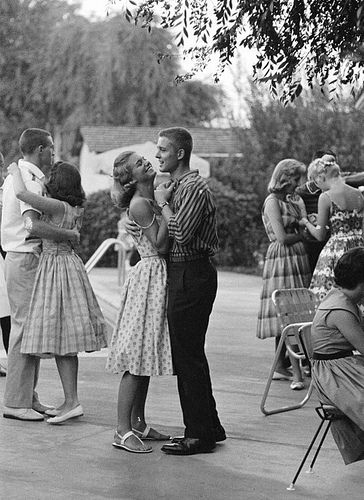 a group of people standing around each other