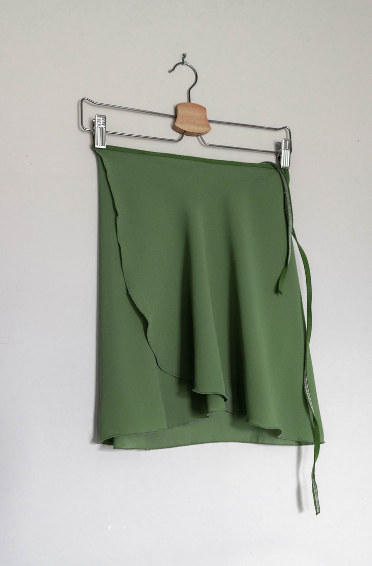 Ready for ballet class? Our classic, green tea -colored wrap ballet skirt is exactly made for that! This ballet dress is handmade with a stretchy green nylon waist tie for a comfortable experience. Crafted 100% out of polyester chiffon with a right above the knee design for a vintage look. ✷ Perfect for Recital ✷ This green ballet dress is the perfect choice for a vintage/classy-style recital. A conservative style with a right above the knee design for a formal performance. Not only that, this s Green Ballet Skirt, Fitted Green Wrap Skirt For Summer, Ballet Fits, Conservative Style, Short Wrap Skirt, Long Wrap Skirt, Fabric Steamer, Conservative Fashion, Ballet Clothes