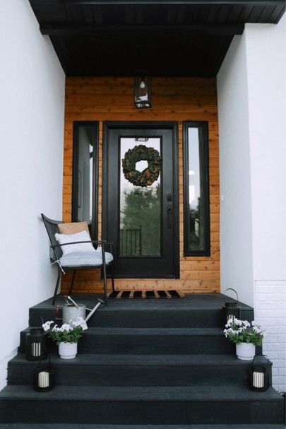 black and white front porch with steps leading up to the door