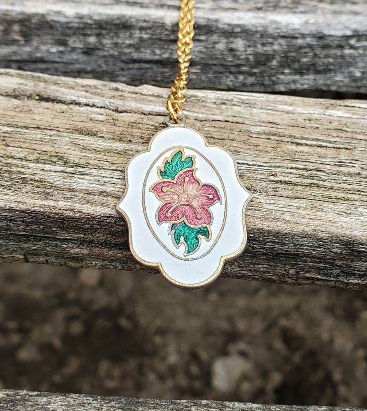 "This is a vintage, cloisonne pendant. It has a pink flower and green leaves on a white background. *I added a necklace on here. Please let me know what color and length you want it to be. This would be a great gift for an anniversary, wedding, Christmas, birthday, or any other occasion. Size: 1 1/4\" x 7/8\"  Condition: Good Maker's Mark: None This model is retired and is no longer in production. All jewelry items come in a gift box." Bridesmaid Wedding, Wedding Christmas, Maker's Mark, Anniversary Wedding, Flower Necklace, Necklace Gift, Pink Flower, Christmas Birthday, Gift For Mom