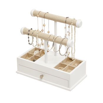 a white jewelry box with two drawers and three necklaces hanging from it's sides