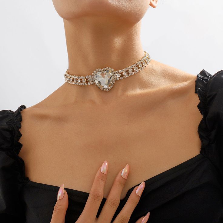 This pendant choker features shimmering cubic zirconia and a heart crystal at the center of it all. Pendant : 1.42" W x 1.42" H Chain : 13.19" L with 4.33" extender Lobster claw clasp 18k gold-plated copper / crystal / cubic zirconia Necklace Korean Style, Necklace Korean, Necklace Love, Heart Choker, Cubic Zirconia Necklace, Sunglass Chain, Women Necklace, Neck Chain, Trendy Necklaces