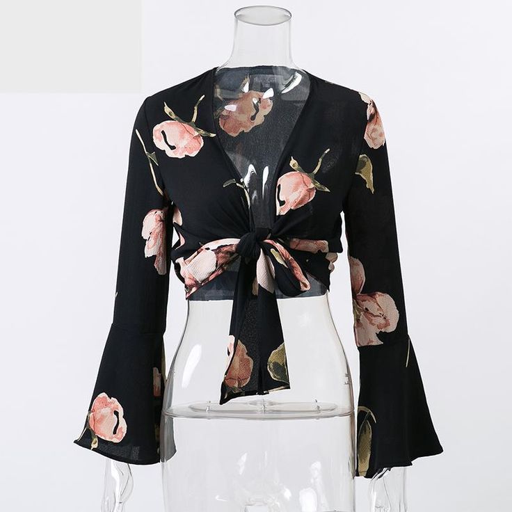 This sexy & sassy floral cropped top is sheer perfection. Made with a cotton & polyester blend and featuring a plunging v-neckline, a tie-up front and flare sleeves this top pairs perfectly with pants, skirts, shorts, jeans or leggings. Egirl Fashion, Black Shirts Women, Short Blouses, Flare Top, Flare Sleeves, Collars For Women, Women Blouses, Spring Tops, Floral Shorts