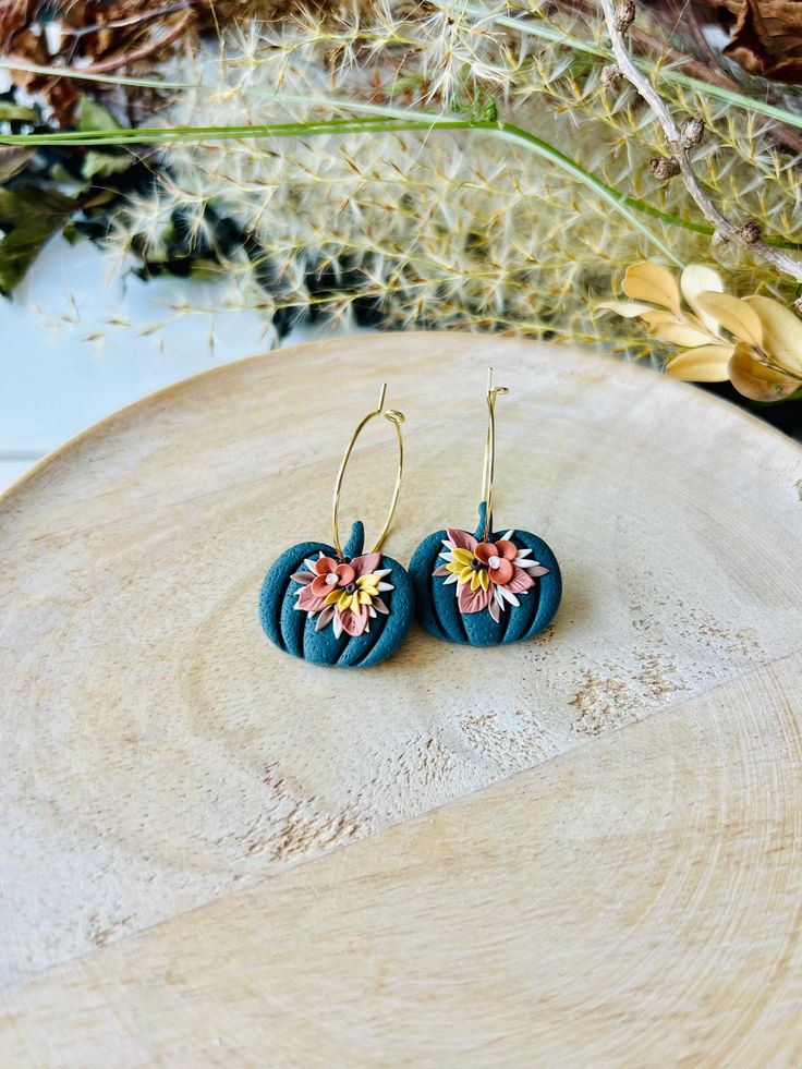 These fun pumpkin hoop earrings have been handmade with polymer clay. All floral detail work is completely done by hand giving each pair a unique look! These are truly one of a kind! You can choose from gold plated stainless steel, antiqued brass or regular stainless steel hoops. All hoops are nickel free, making these great for sensitive ears. The hoops are about 1 inch in diameter. The clay pumpkins are about 1 inch in width. The total length of the earrings is about 1.5 inches. These earrings are super lightweight and so comfortable to wear! Very cute for fall and Halloween! Be sure to check out our shop for more colors! www.etsy.com/shop/theglassbird Also come like our facebook page to receive updates on new items, coupon codes and future giveaways! https://www.facebook.com/TheGlassBir Handmade Hoop Flower Earrings For Gift, Whimsical Handmade Clay Earrings, Small Hoop Polymer Clay Earrings With Ear Wire, Hoop Earrings In Polymer Clay For Gift, Handmade Unique Polymer Clay Flower Earrings, Unique Handmade Polymer Clay Flower Earrings, Handmade Polymer Clay Round Hoop Earrings, Handmade Small Hoop Earrings In Polymer Clay, Handmade Gold Hoop Earrings With Polymer Clay