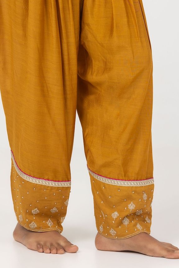 Mustard yellow short A-line kurta with floral block print and sequin embroidered yoke. Paired with matching embroidered hem salwar. - Aza Fashions Salwar Pattern, Short Kurta, A Line Kurta, Fabric Beads, Trouser Pants Women, Yellow Shorts, Embroidered Shorts, Pants Pattern, Embroidered Silk