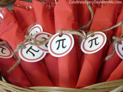 red napkins tied together in a wicker basket with tags on them that say pi