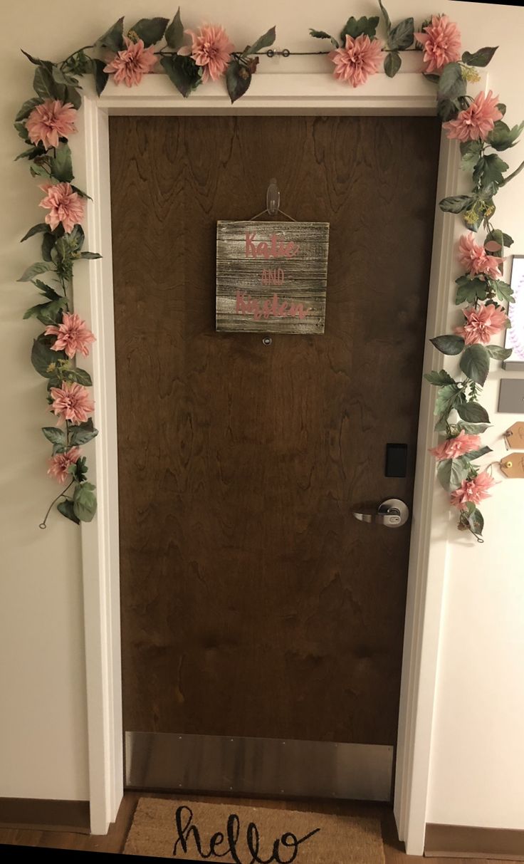 the door is decorated with pink flowers and leaves