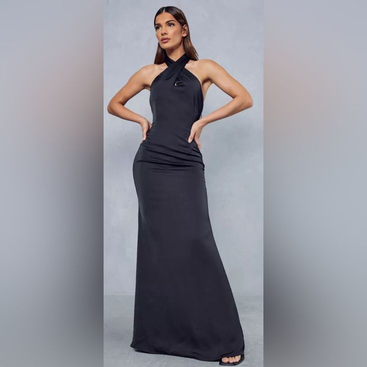 Crafted From High-Quality Satin Material, This Dress Boasts A Solid Pattern In Classic Black Color That Is Versatile Enough To Match Any Accessories. With Its Comfortable Fit And Glamorous Style, You'll Surely Turn Heads Wherever You Go. Don't Miss Out On This Must-Have Addition To Your Wardrobe. Black Floor-length Halter Dress For Night Out, Black Floor-length Halter Evening Dress, Black Halter Neck Evening Dress For Night Out, Black Maxi Length Halter Dress For Party, Black Halter Maxi Dress For Party, Black Halter Maxi Dress For Night Out, Black Halter Neck Maxi Dress For Evening, Black Fitted Halter Dress For Evening, Fitted Black Evening Dress With Halter Neck