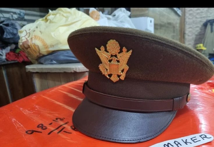 a hat with an eagle on it sitting on top of a red table in a room